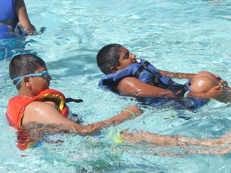 Two scouts swimming in a pool